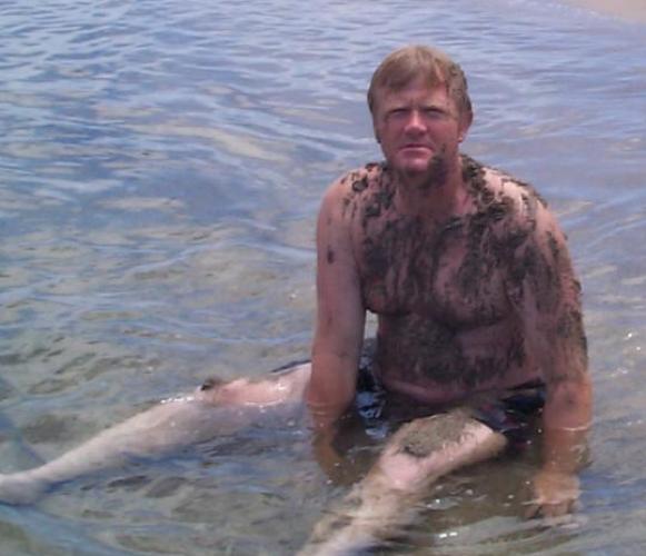 fat daddie bearish man sitting in pond muddy