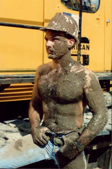 man covered in muddy filthy grime