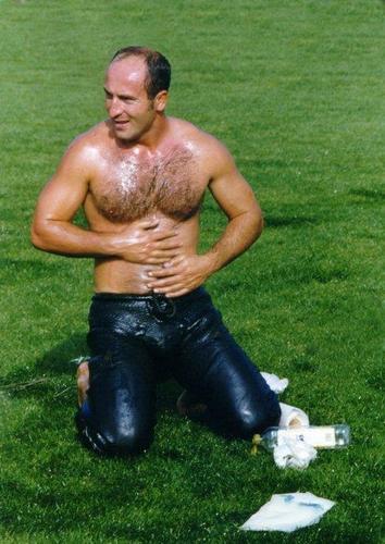 man rubbing lube onto body hairychest mens wrestling